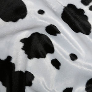 Black and white cow print fabric texture.