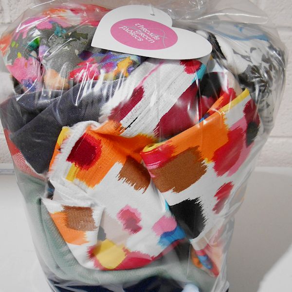 Bag of colourful fabric scraps wrapped in plastic.