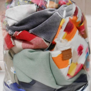 Colourful fabric scraps in a clear plastic bag.
