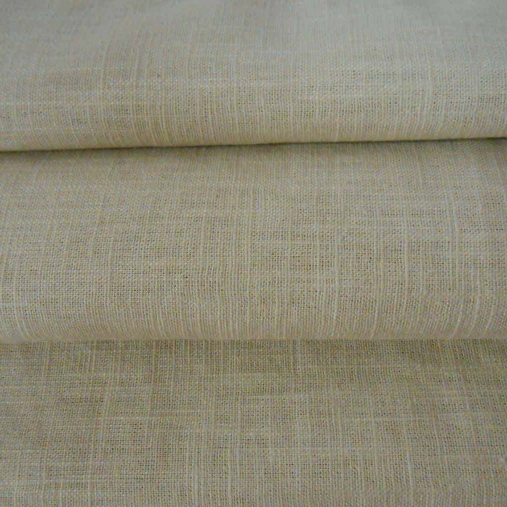 Stacked beige linen fabric close-up.