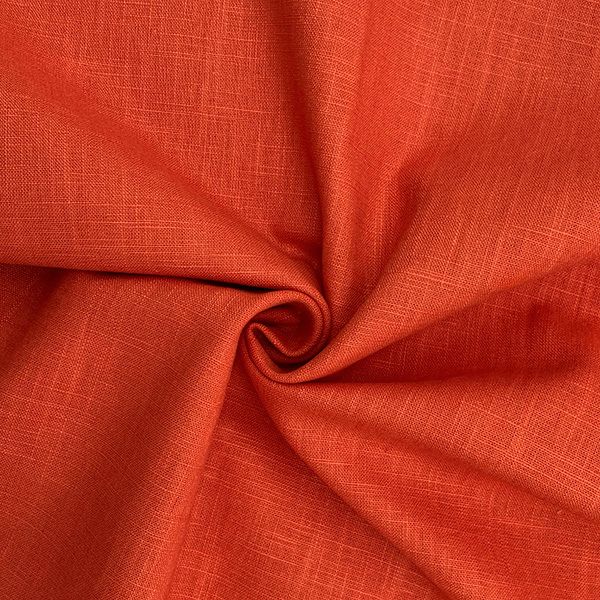 Bright orange fabric with detailed texture folds.