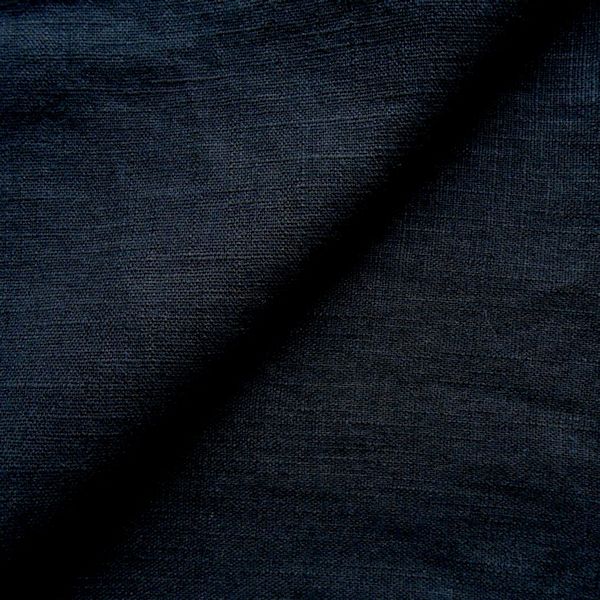 Dark blue textured fabric, folded diagonally