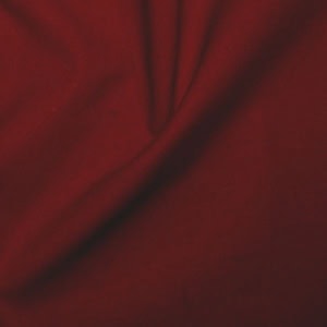 Red fabric with folds and shadows.