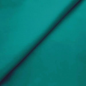 Close-up of folded teal fabric texture.