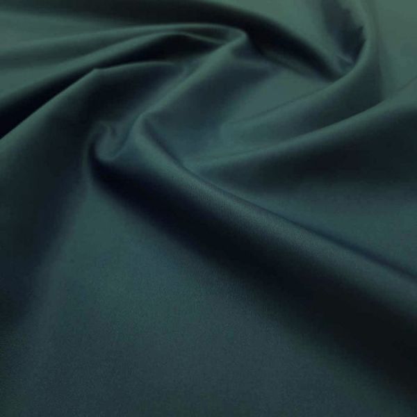 Smooth dark green fabric with gentle folds.