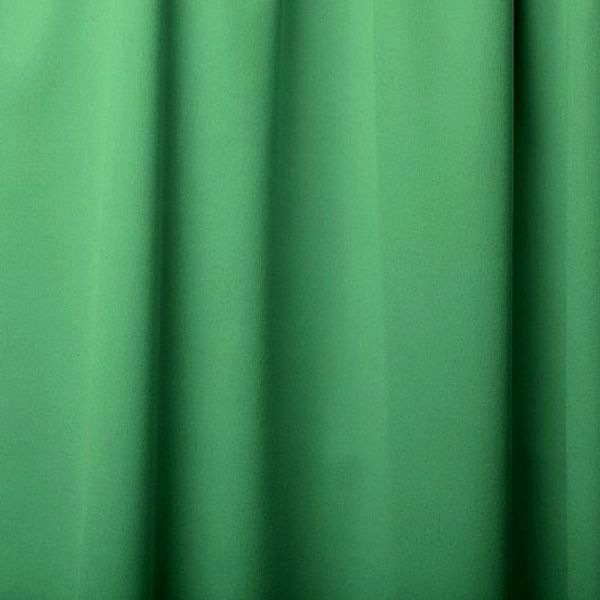 Close-up of green curtain fabric with folds.