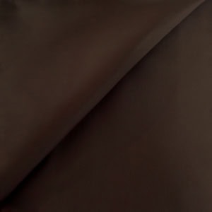Close-up of smooth dark brown leather texture.