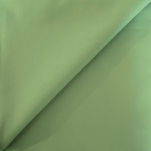 Folded green satin fabric close-up