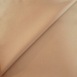 Beige fabric folded in soft layers.