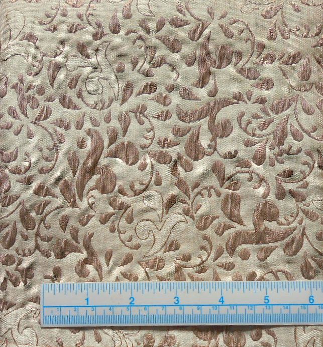 Floral brocade fabric pattern with ruler for scale.