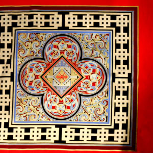Ornate geometric pattern with red, blue, gold accents.