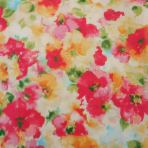 Colourful floral fabric pattern with pink and orange flowers.