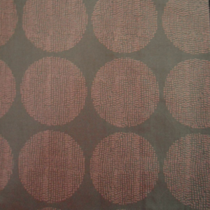 Red dotted circles on dark fabric background.